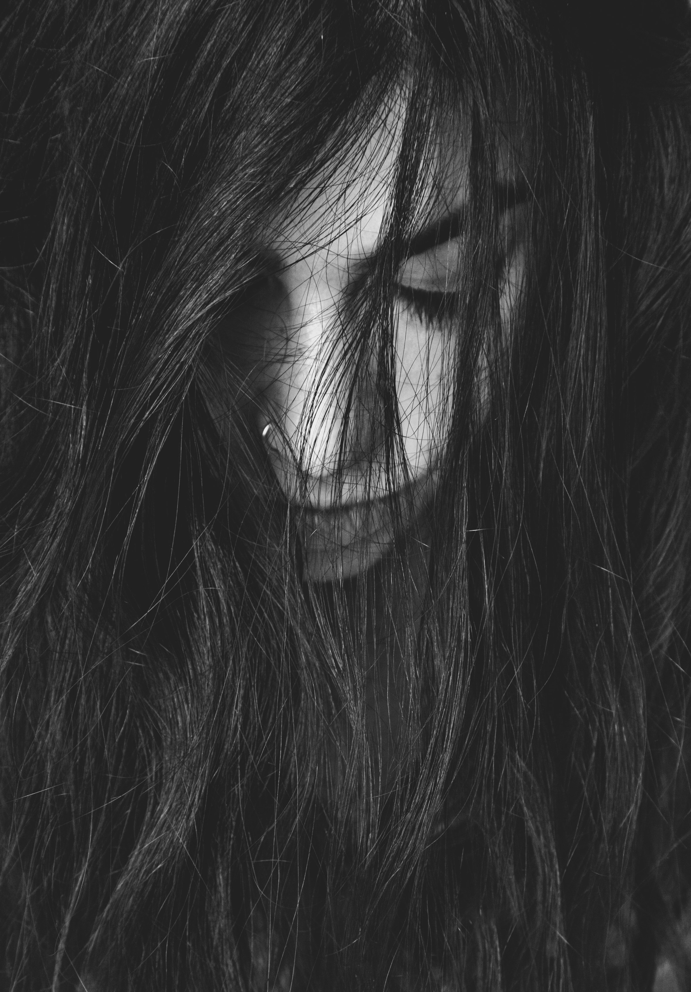 grayscale photography of woman looking down